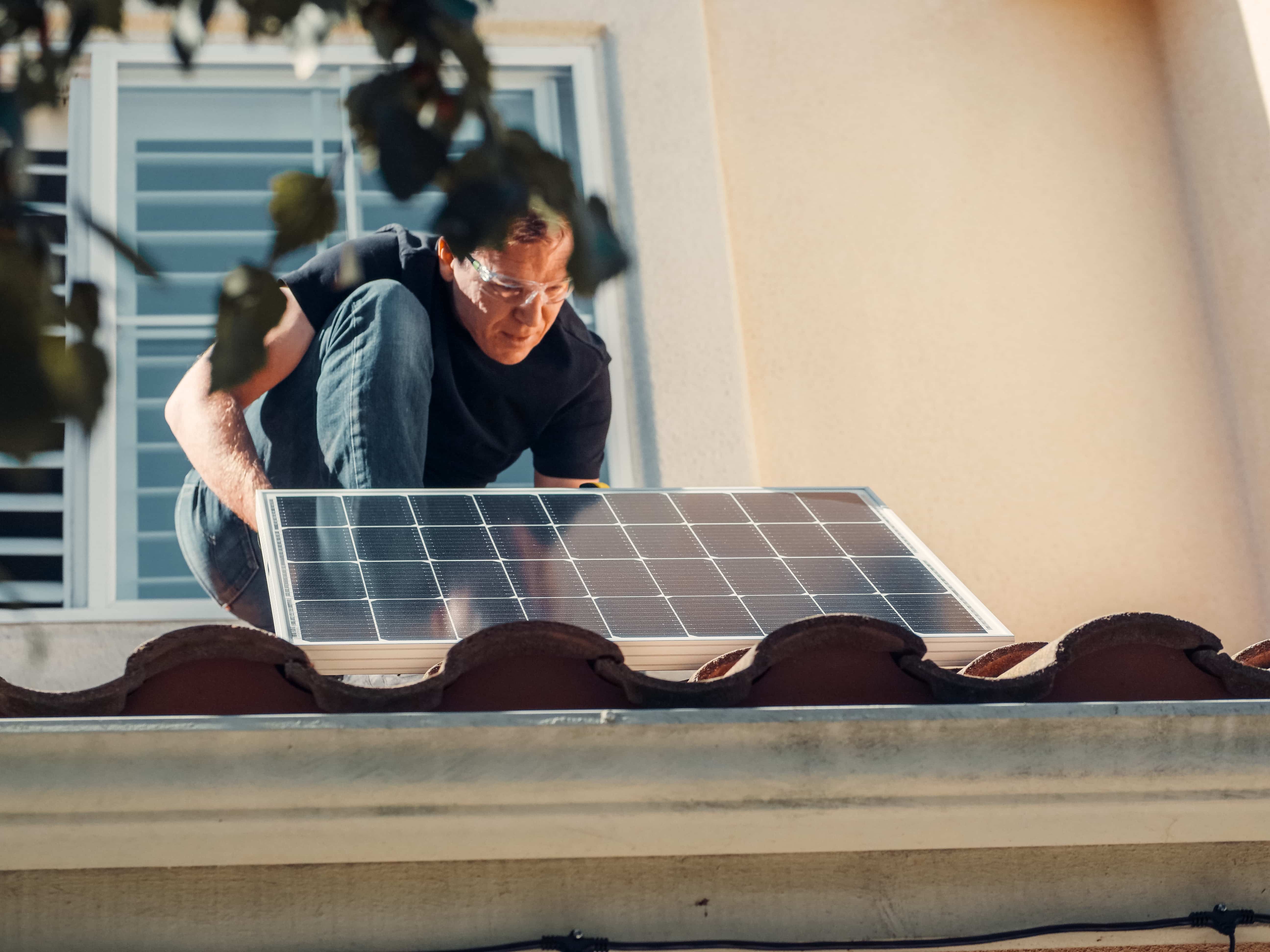 Man installing solar panels.
